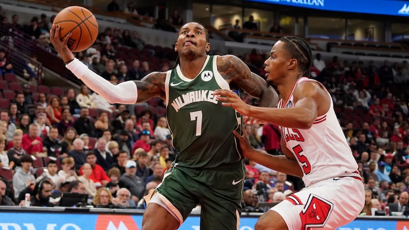 Milwaukee Bucks guard Kevin Porter Jr, left, is defended by Chicago Bulls guard Isaac Okoro,...