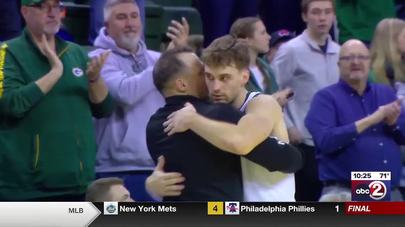 Green Bay guard Preston Ruedinger hugging head coach Doug Gottlieb when exiting the floor on...