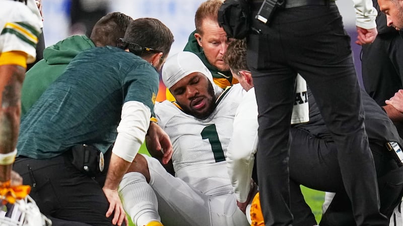 Green Bay Packers' Micah Parsons reacts after an injury during the second half of an NFL...