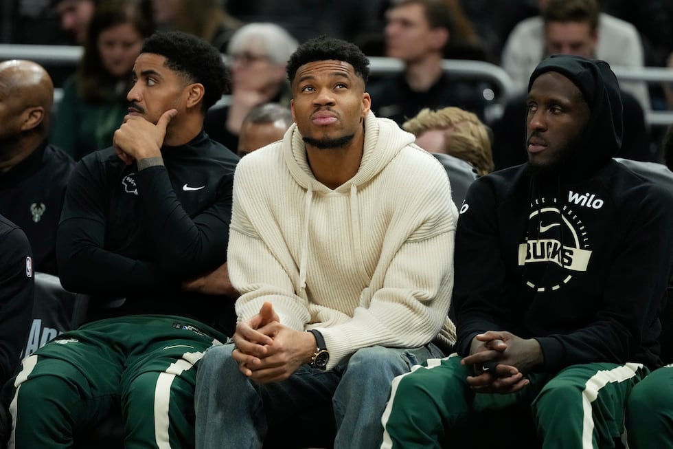Milwaukee Bucks' Giannis Antetokounmpo looks on from the bench during the second half of an...