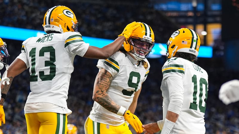 Green Bay Packers wide receiver Christian Watson (9) celebrates a touchdown with wide receiver...