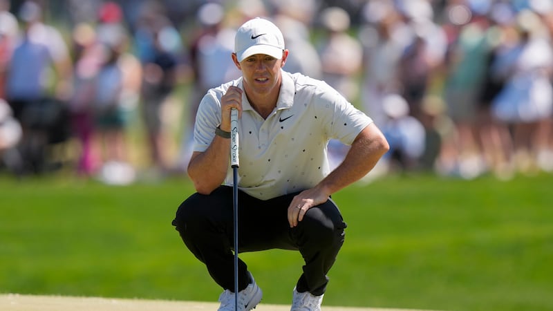 Rory McIlroy, of Northern Ireland, lines up his shot on the 16th green during the third round...