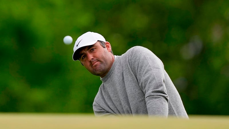 Scottie Scheffler chips onto the ninth green during the first round of the PGA Championship...