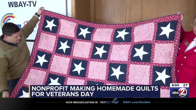 U.S. Marines SSgt. Patrick Garcia (left) receives a gift from Quilts of Valor