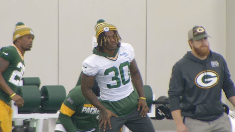 Packers RB Jamaal Williams stretches with the team on Friday inside the Don Hutson Center in...