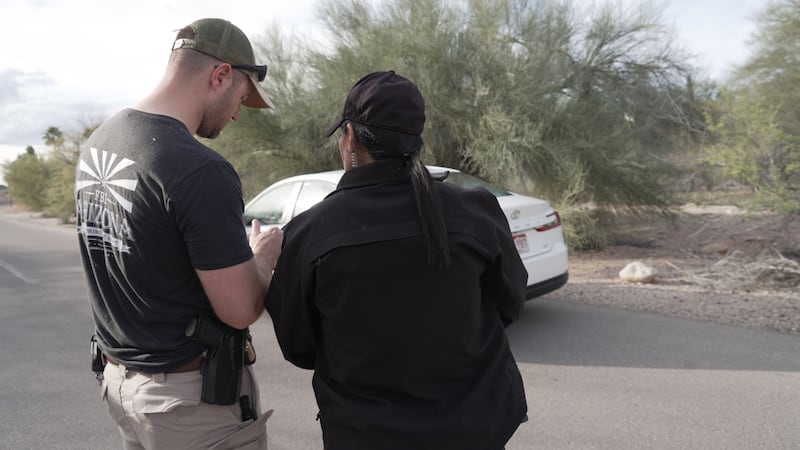 Investigators walk around homes in the neighborhood where Annie Guthrie, whose mother Nancy...
