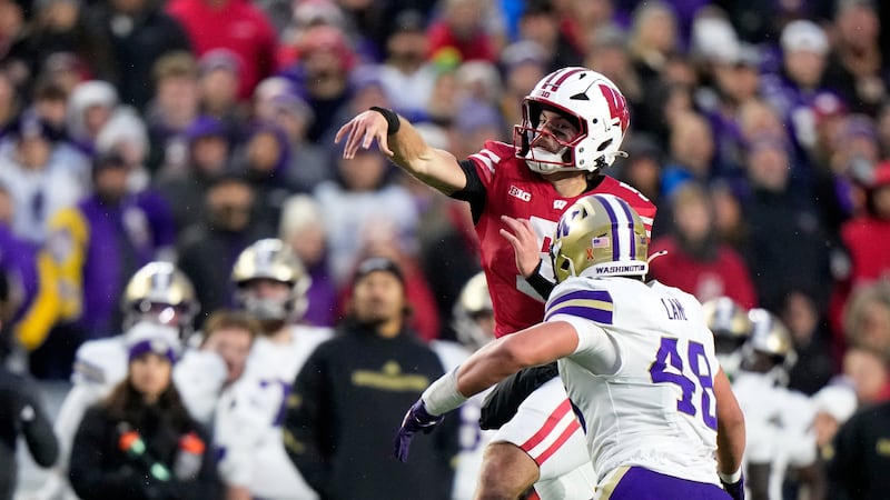 Wisconsin's Carter Smith throws in front of Washington's Jacob Lane during the first half of...