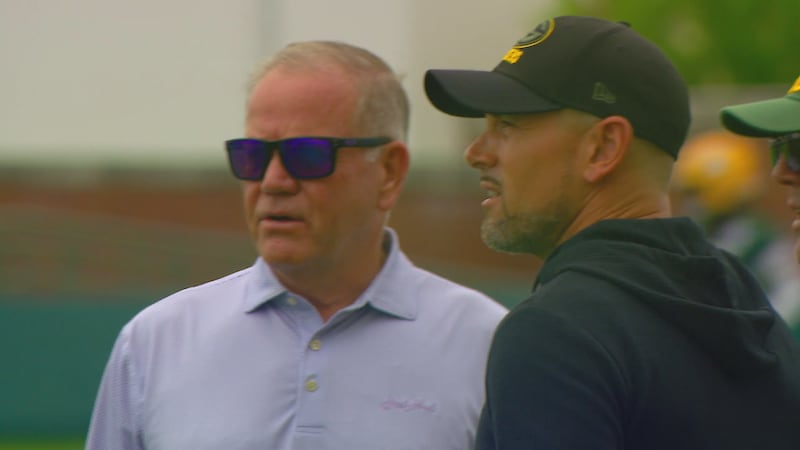 Matt LaFleur talks with former college head coach Brian Kelly during Packers practice.