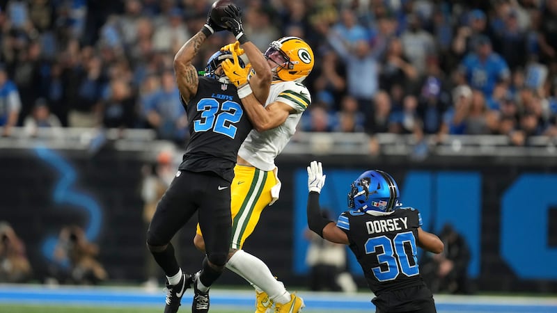 Detroit Lions cornerback Brian Branch (32) intercepts a pass intended for Green Bay Packers...