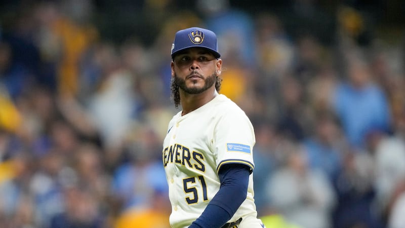 Milwaukee Brewers pitcher Freddy Peralta walks to the dugout after the top of the fifth inning...
