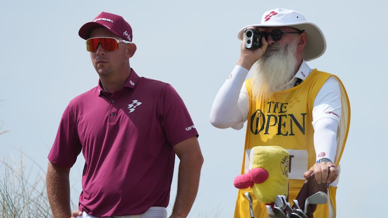 Lucas Herbert of Australia with his caddie Nick Pugh, look at the 13th hole from the tee...